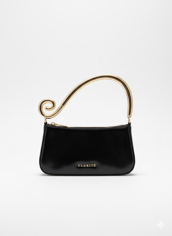 Black handbag with gold handle on a white background