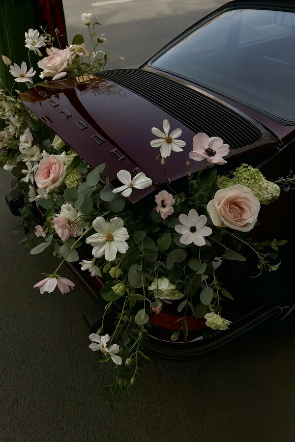 Car hood decorated with flowers and greenery