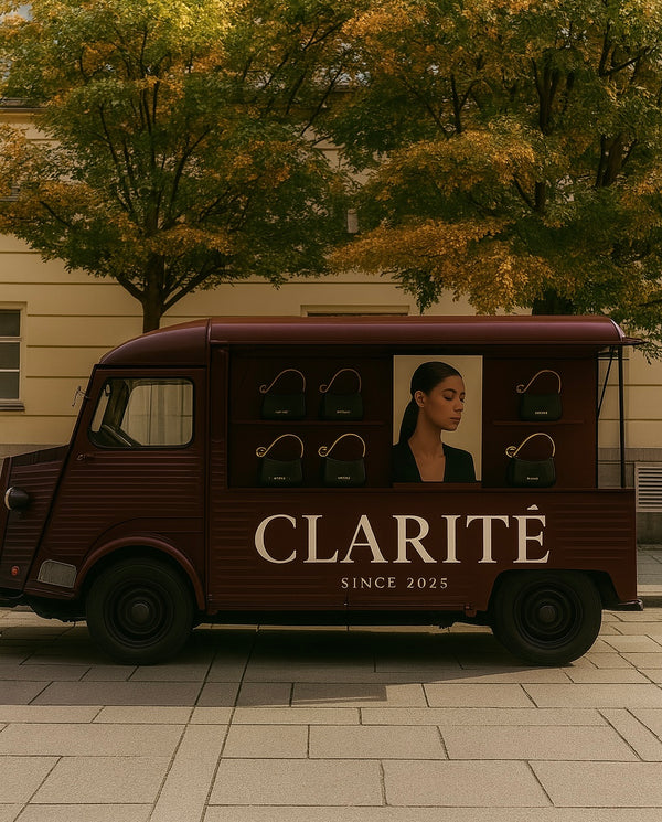 Vintage-style truck with 'Clarité' branding and a woman's face on a city street.
